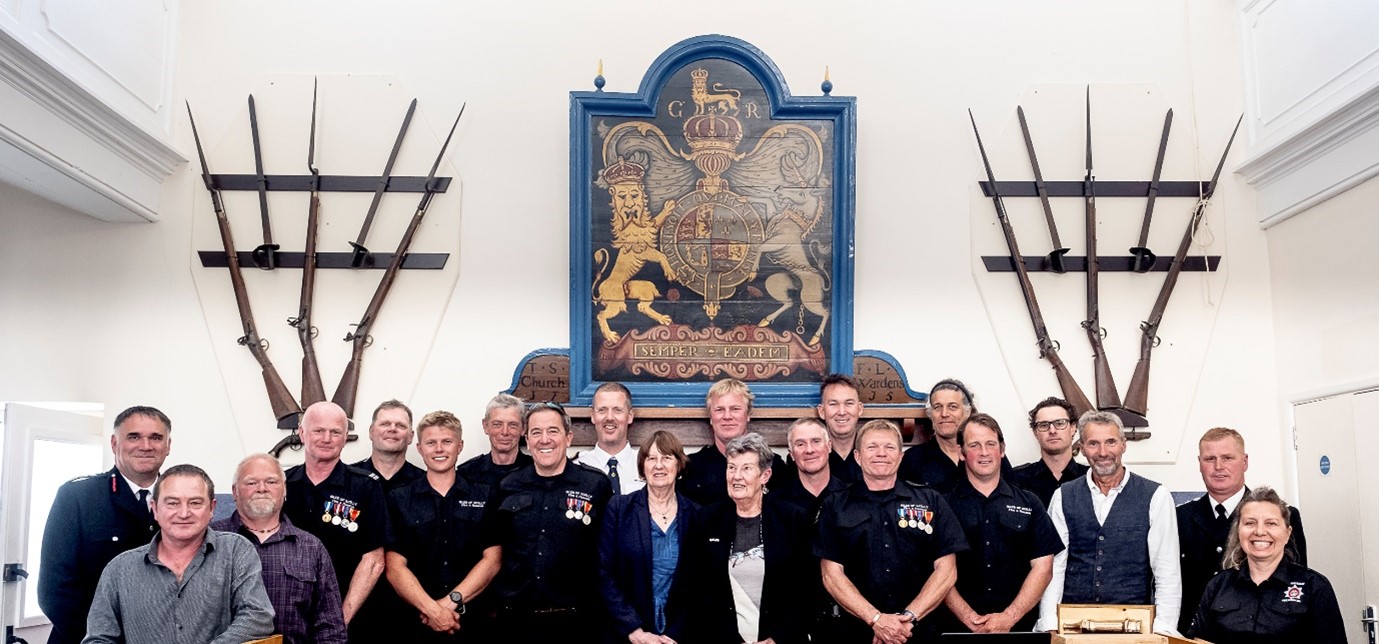 Image of Members of the Isles of Scilly Fire and Rescue crew with Councillors in the Council Chamber at the Wesleyan Chapel on St Mary's.