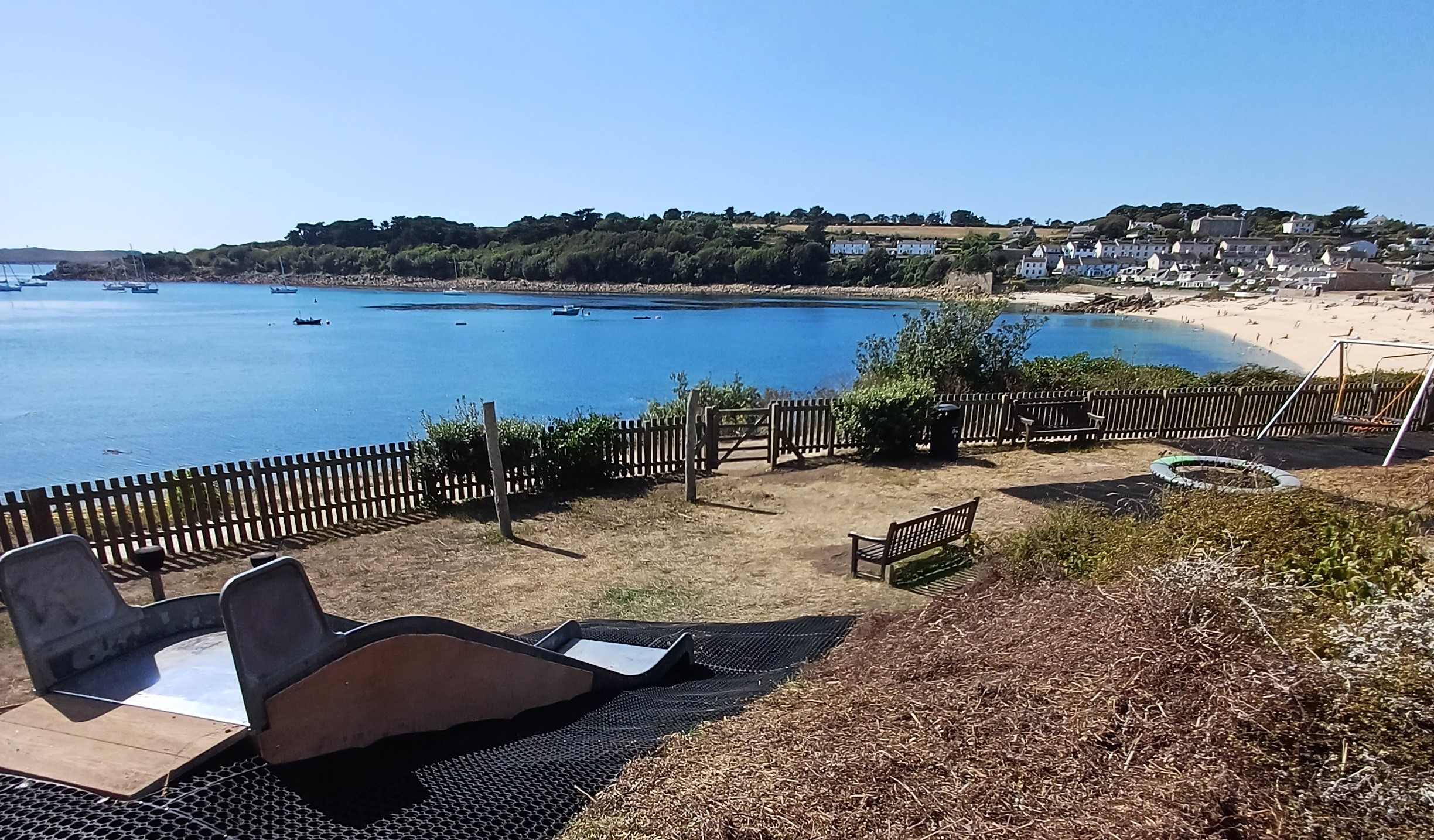 Image of the view over the bay from the top of the slide at the newly reopened play park at Porthcressa on St Mary's